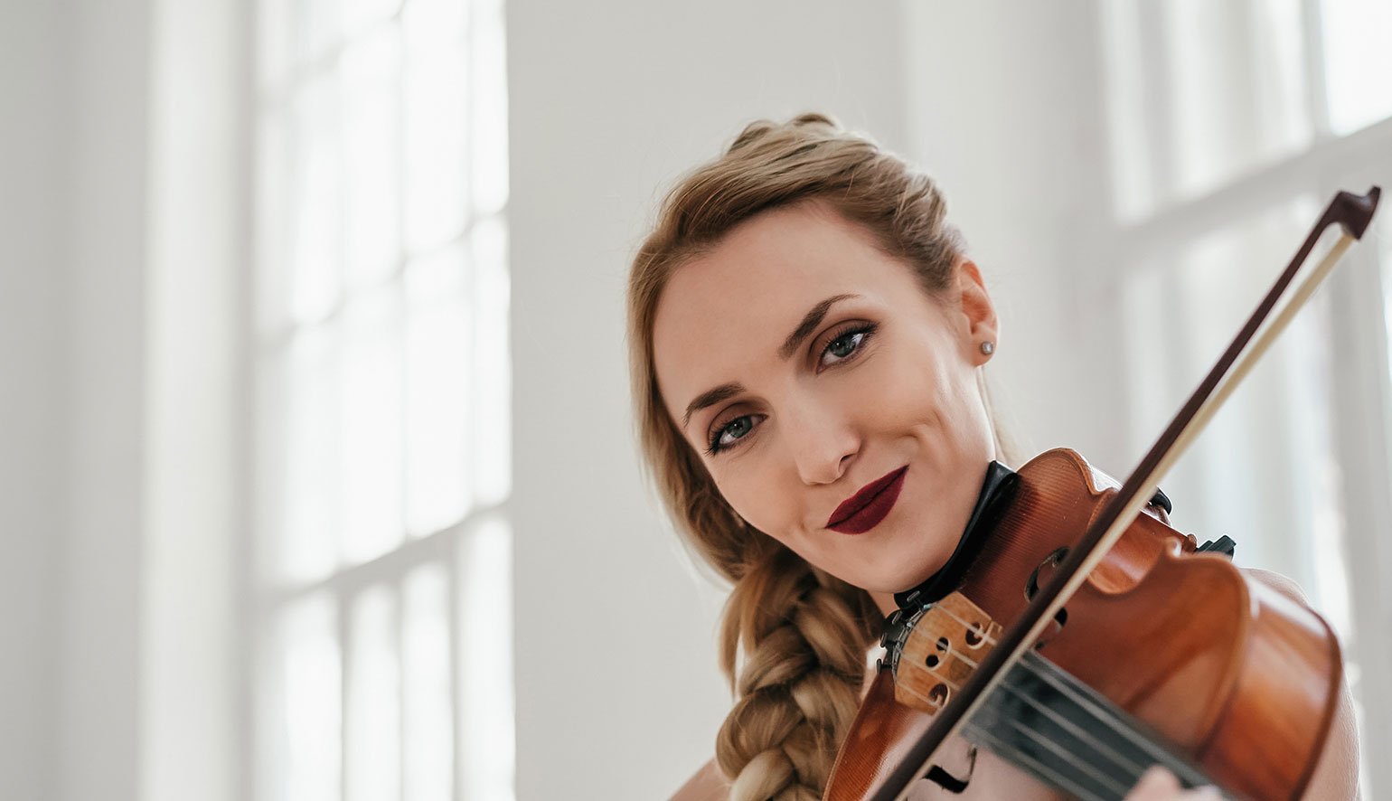 The prefect violin being played by a beautiful confident women
